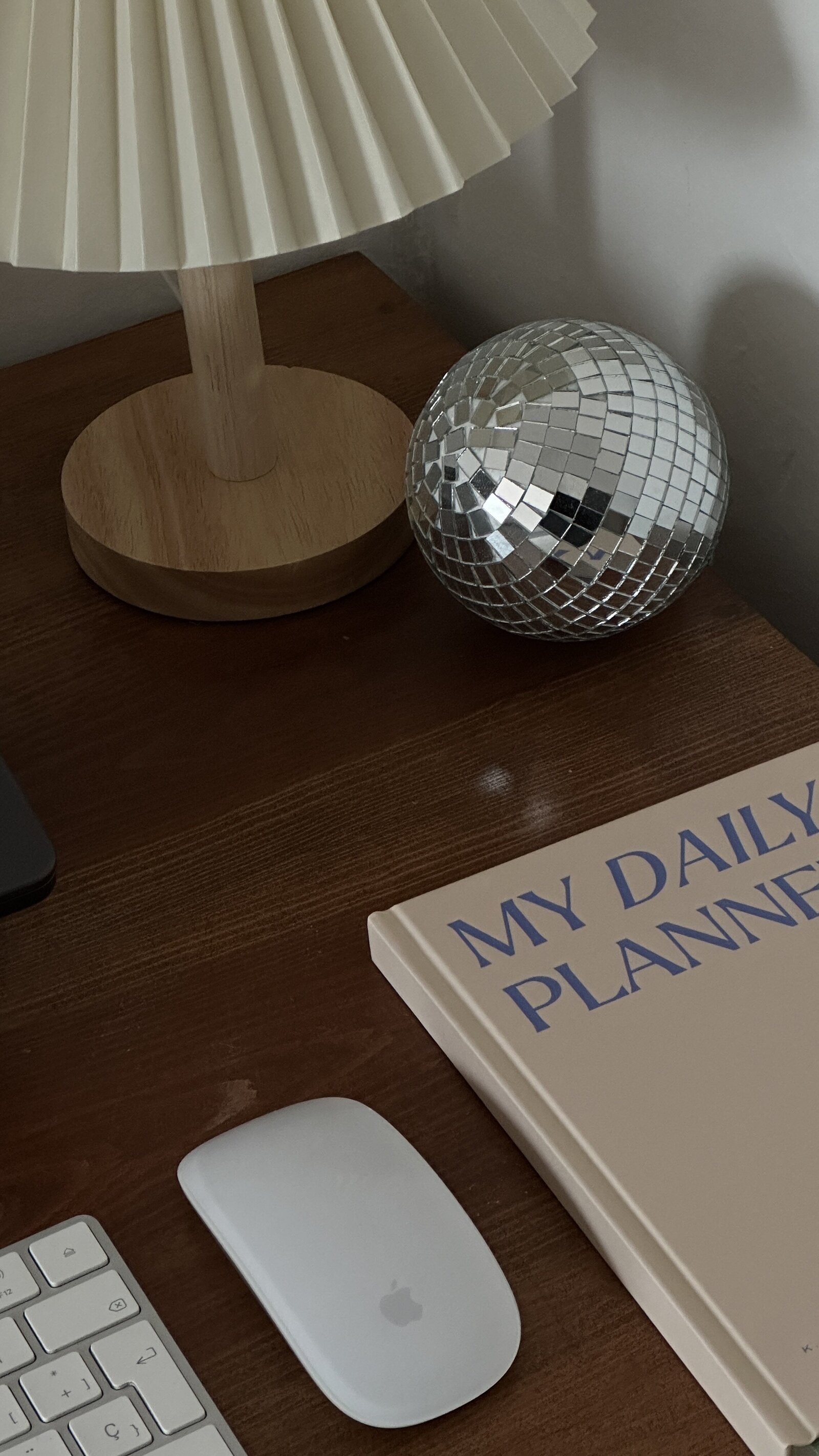 Bright Side desk still life with a pleated lamp and disco ball